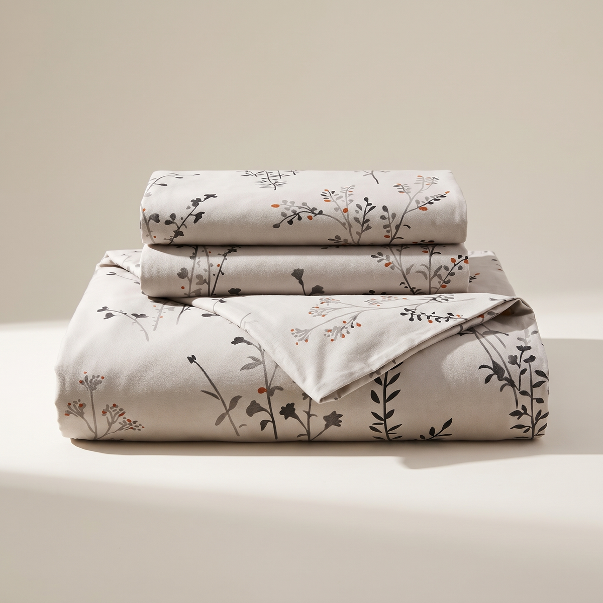 Willow Duvet Cover Set, folded stack, dark wildflower stems on warm stone