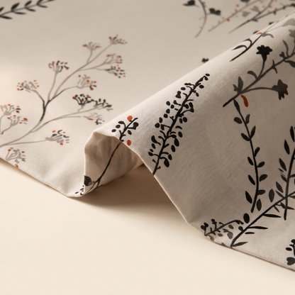Willow Sheet Set, fold detail, dark wildflower stems on warm stone