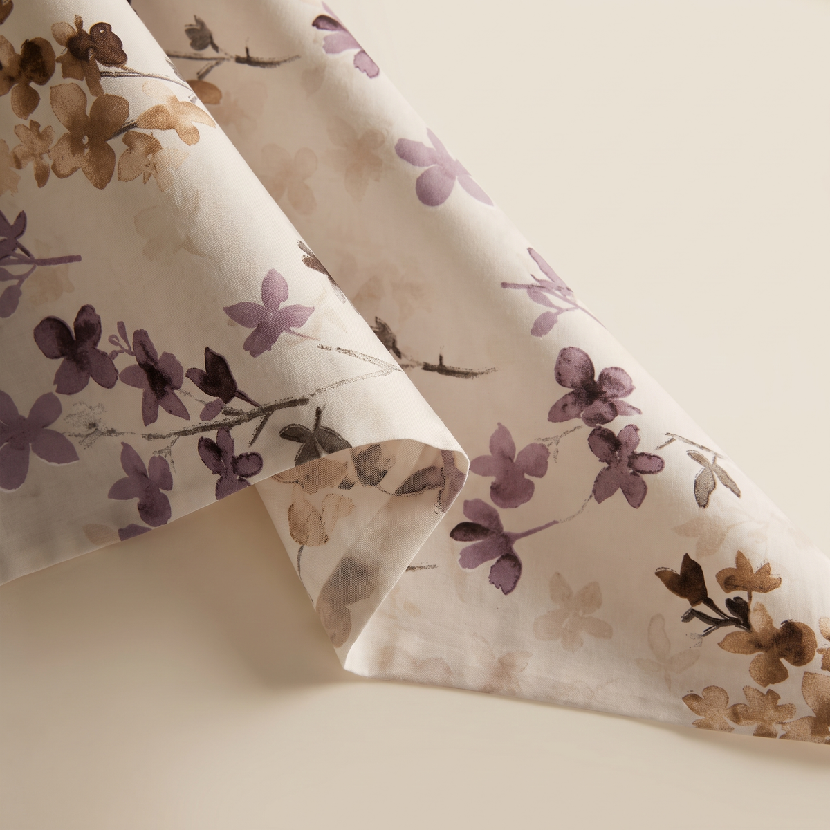 Blossom Sheet Set, fold detail, plum and mauve blossoms on cream