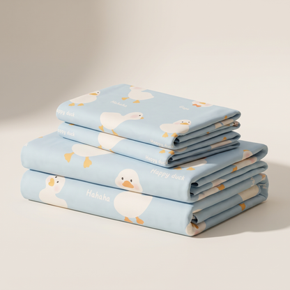 Puddle Sheet Set, folded stack, little ducks on pale blue