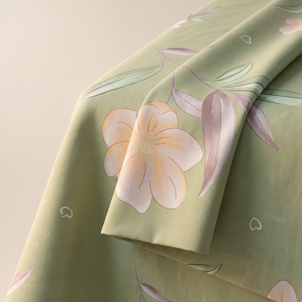 Lotus Sheet Set, fold detail, pale pink lotus flowers on sage green