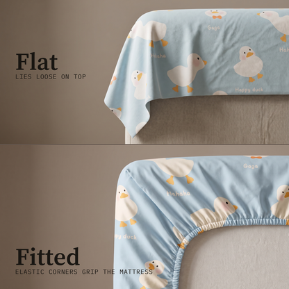 Puddle Sheet Set, flat and fitted sheet side by side, little ducks on pale blue