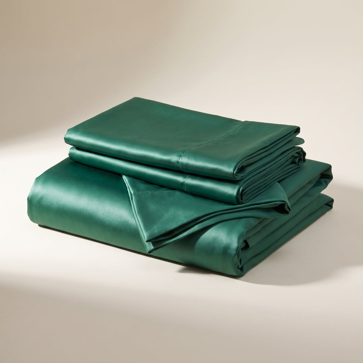 Emerald Satin Sheet Set — folded stack