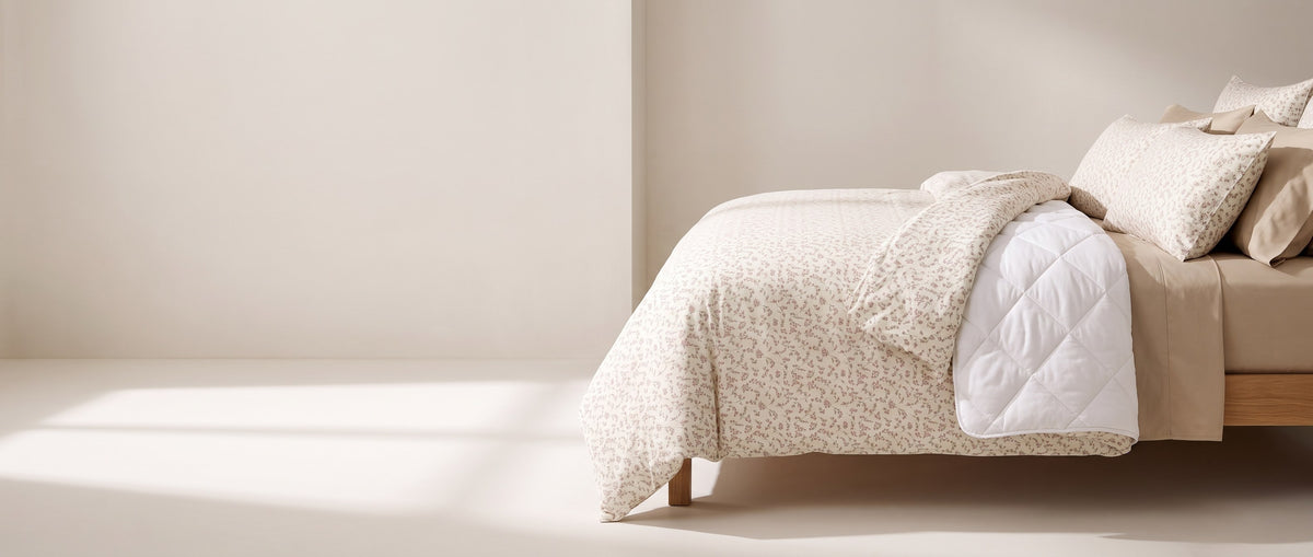 A made bed with the corner turned back to show the cover, duvet and sheet